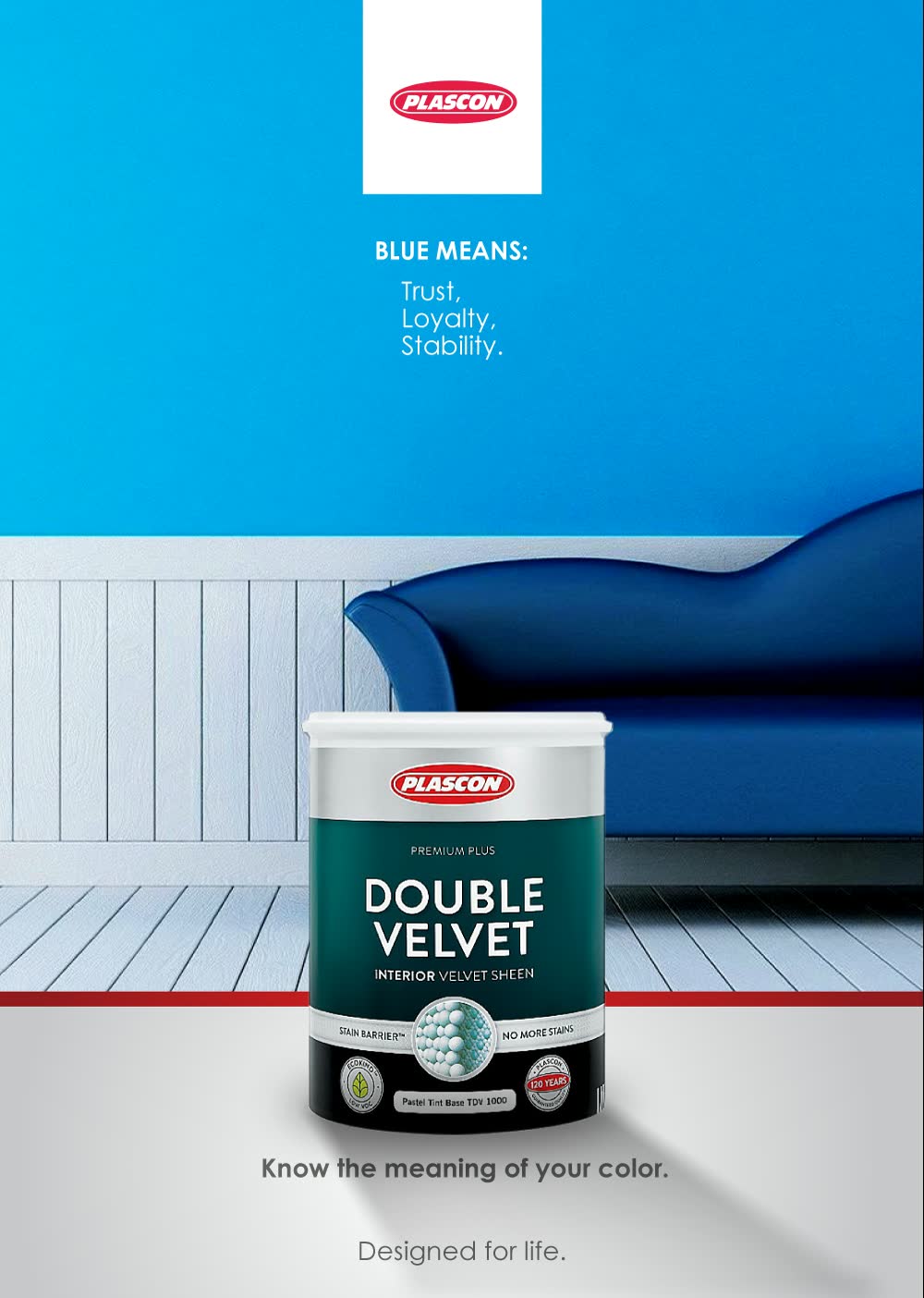 A blue wall, a blue sofa and a tin of paint